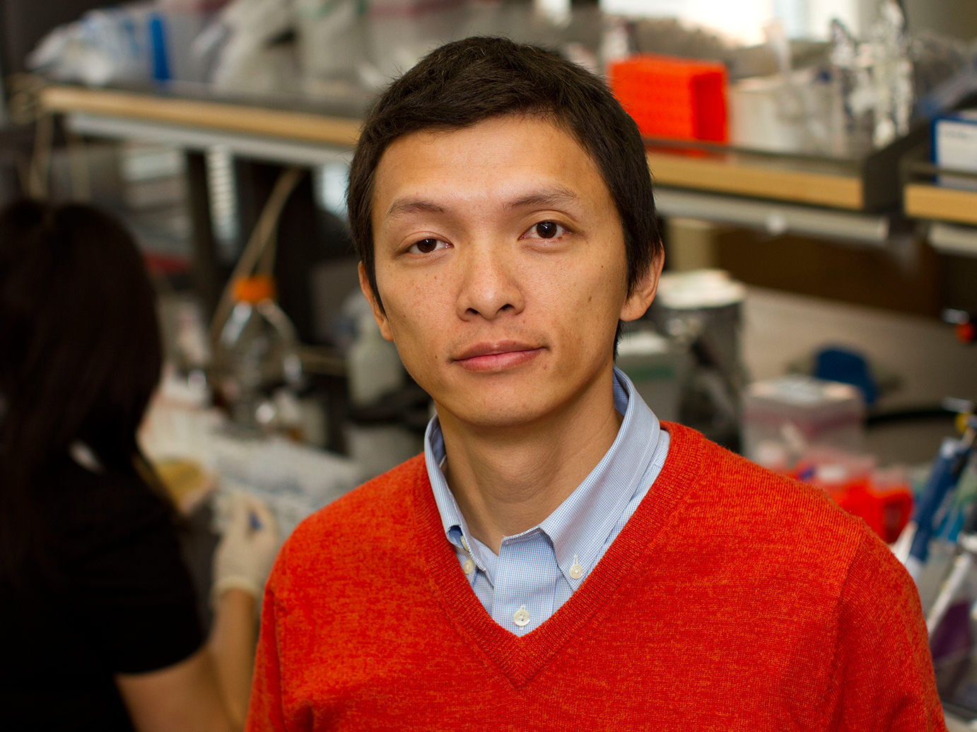 Portrait: Xiao Wang, standing in his lab